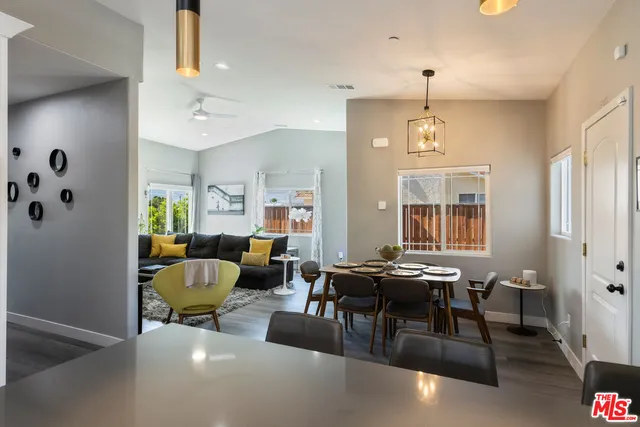 a open dining room with furniture kitchen view and a wooden floor