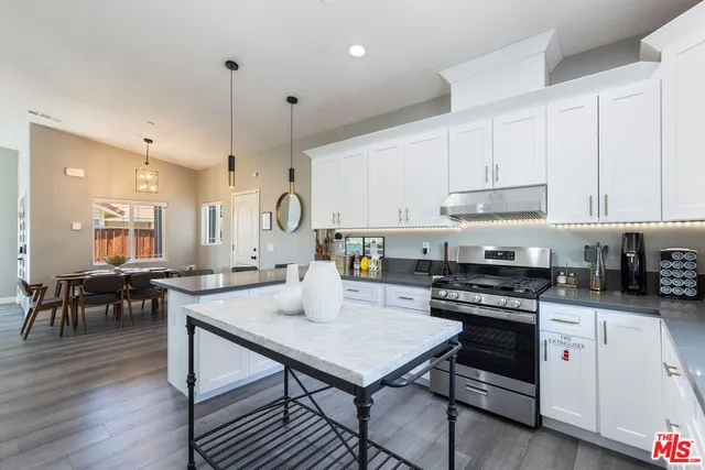 a kitchen with sink cabinets and wooden floor