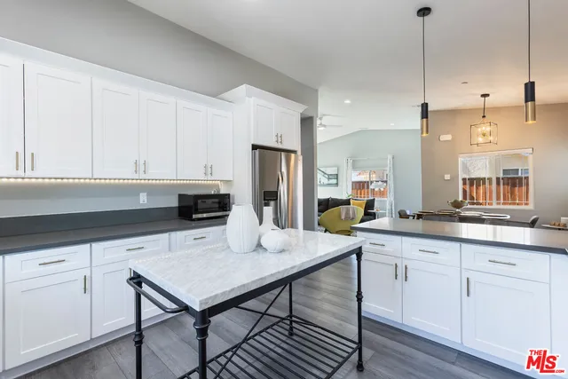 a kitchen with sink stove and cabinets