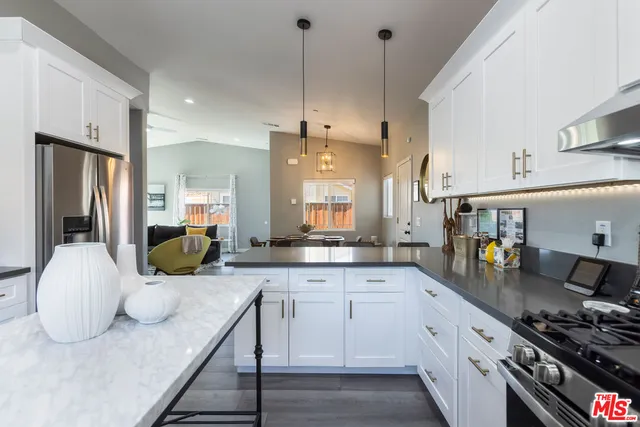 a kitchen with cabinets appliances and a counter top space