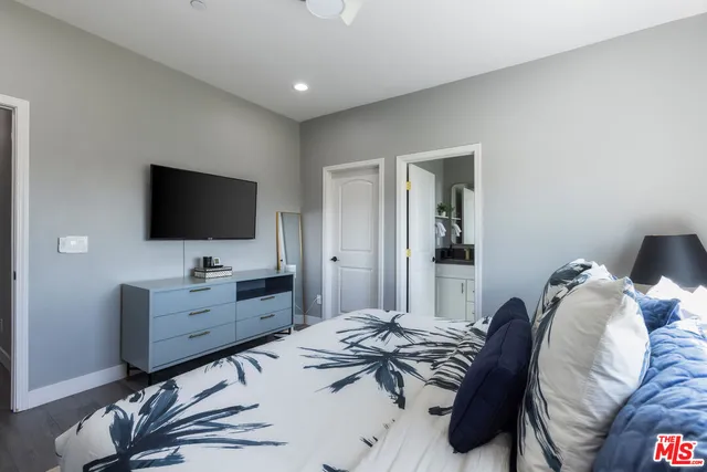 a bedroom with furniture and a flat screen tv