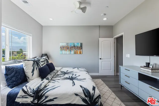 a bedroom with a bed and a flat screen tv