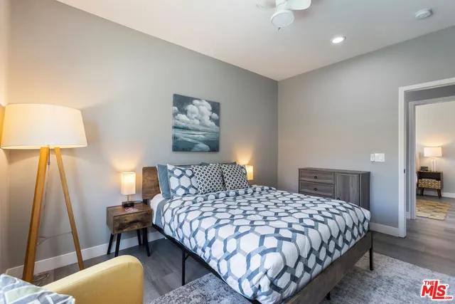 a bedroom with a bed and a lamp