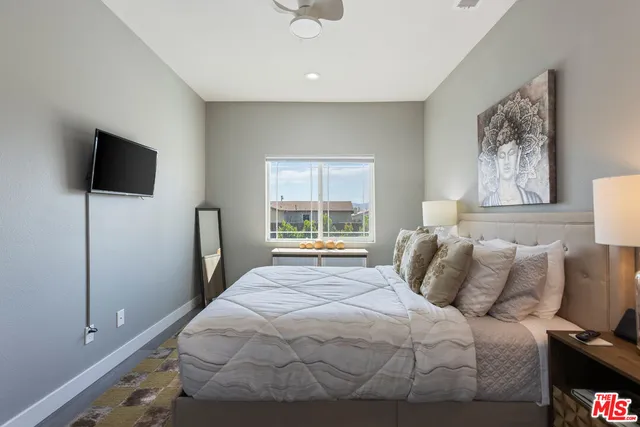 a bedroom with a bed and a flat screen tv