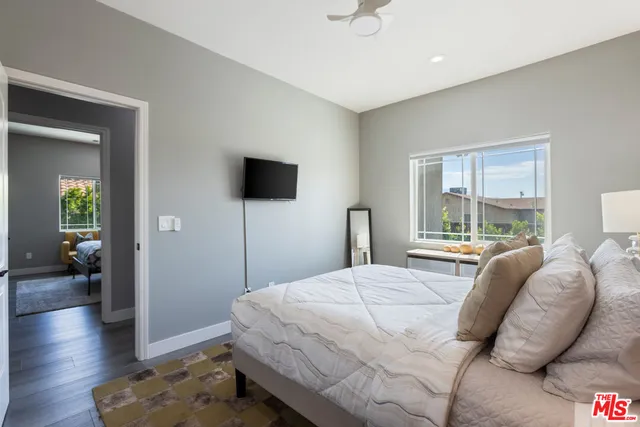 a bedroom with a large bed and a window
