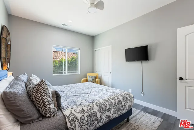 a bathroom with a granite countertop sink a toilet and bathtub