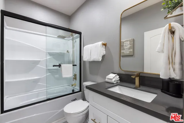 a view of a house with swimming pool and sitting area