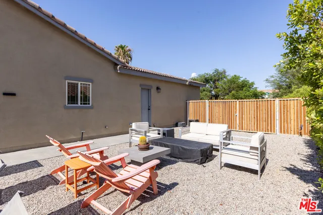 a view of a patio with chairs and a table