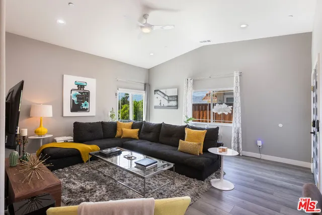 a living room with furniture and wooden floor
