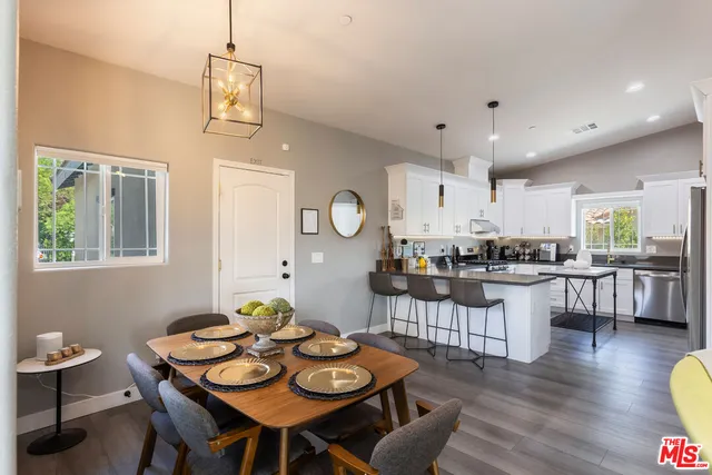 a view of a dining room with furniture and wooden floor