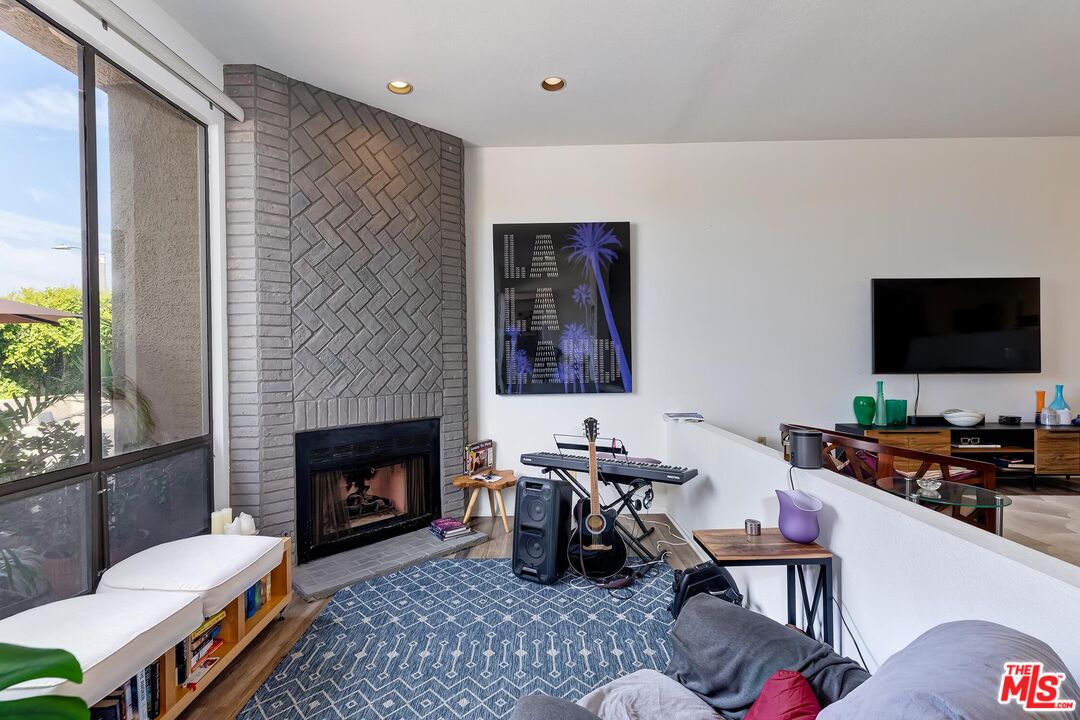 132 Convoy Street Playa del Rey, CA 90293 - Photo 3 of 16 a living room with furniture a flat screen tv and a fireplace