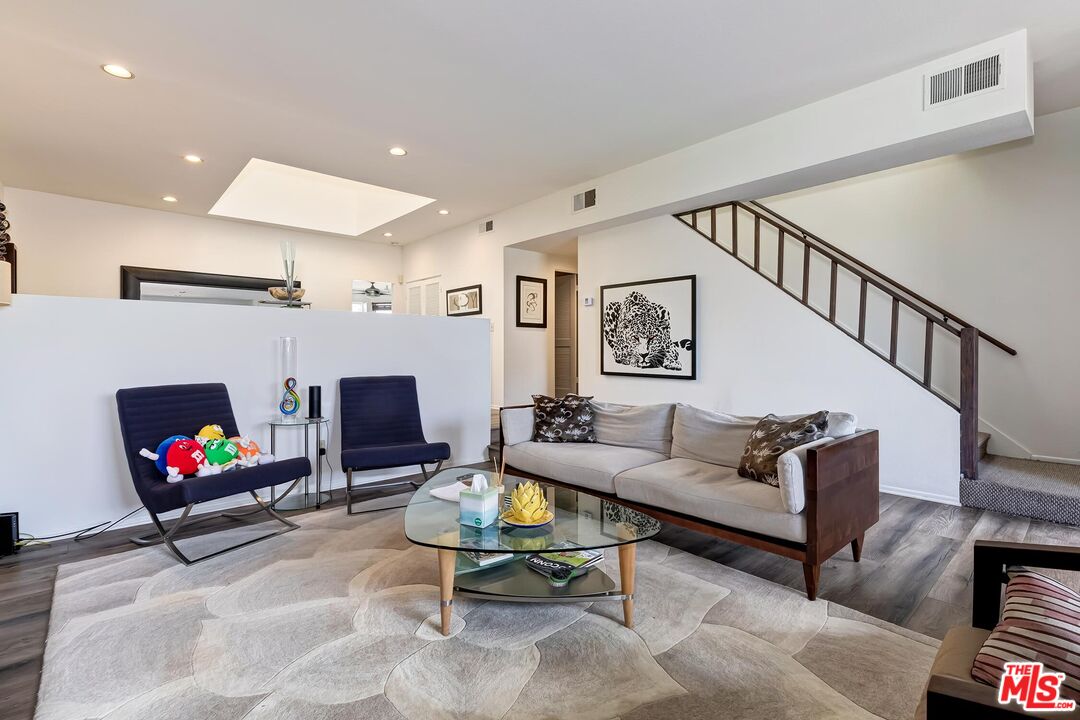 132 Convoy Street Playa del Rey, CA 90293 - Photo 4 of 16 a living room with furniture a flat screen tv and a fireplace