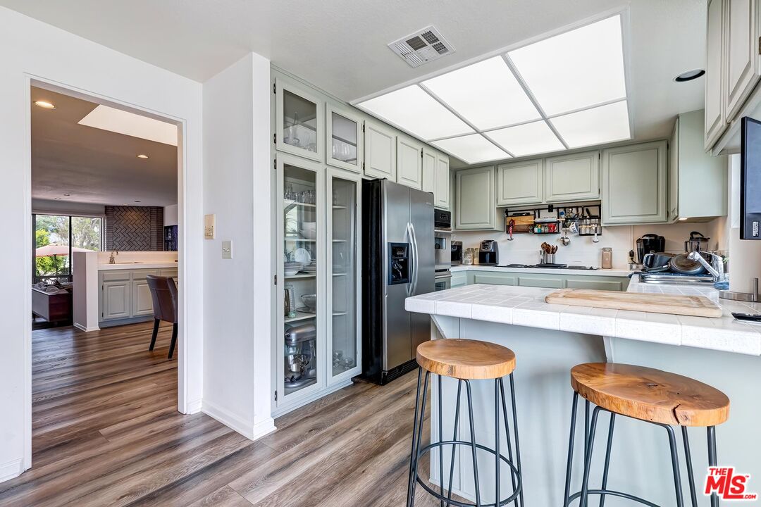 132 Convoy Street Playa del Rey, CA 90293 - Photo 6 of 16 a kitchen with stainless steel appliances granite countertop a refrigerator a sink and a stove