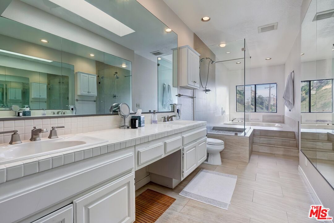 132 Convoy Street Playa del Rey, CA 90293 - Photo 8 of 16 a large bathroom with a large mirror vanity sink and