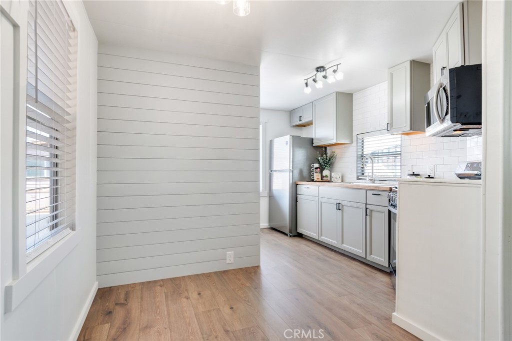 975 California Street, Unit 72 Calimesa, CA 92320 - Photo 11 of 23 a kitchen with cabinets and wooden floor