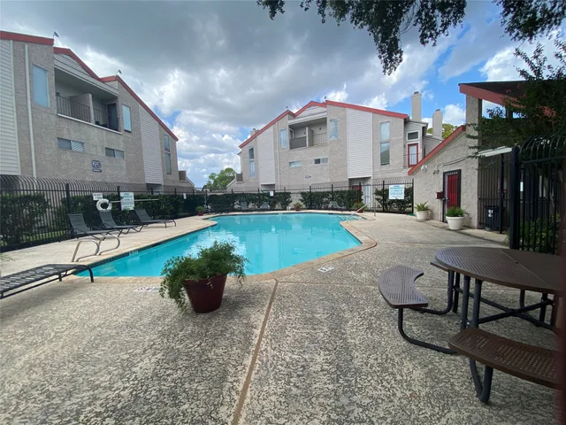 a swimming pool with outdoor seating and yard