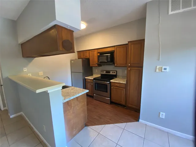 a kitchen with a sink cabinets and stainless steel appliances