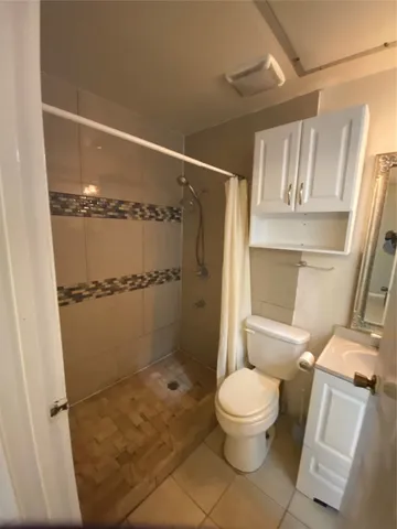 a bathroom with a toilet and a shower
