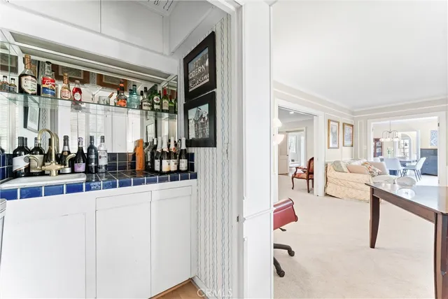 a living room with furniture and a kitchen view