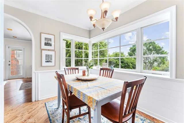 a view of a dining room with furniture large windows and wooden floor