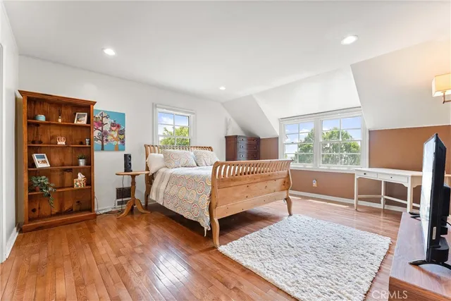 a bedroom with a bed and a chair in it