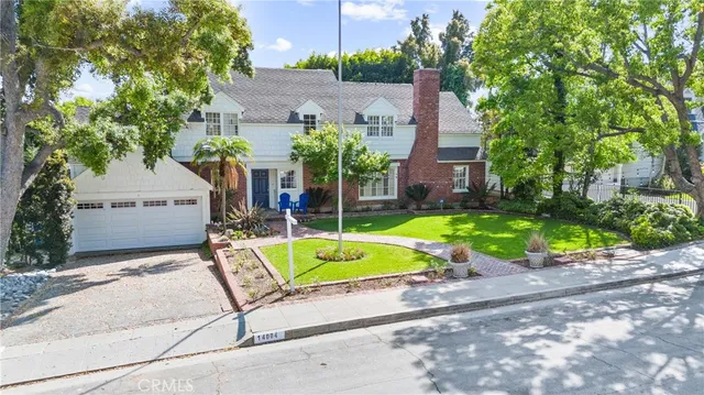 a view of a house with a yard and sitting area