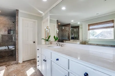 a bathroom with a double vanity sink and a mirror