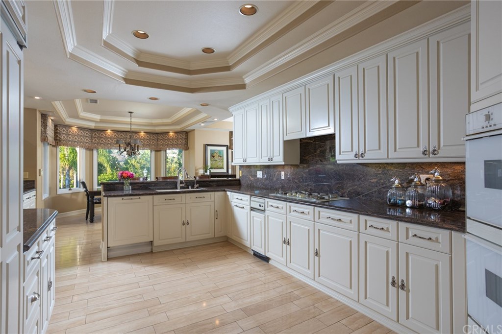 19051 Mesa Drive Villa Park, CA 92861 - Photo 20 of 28 a large white kitchen with lots of counter space and a window