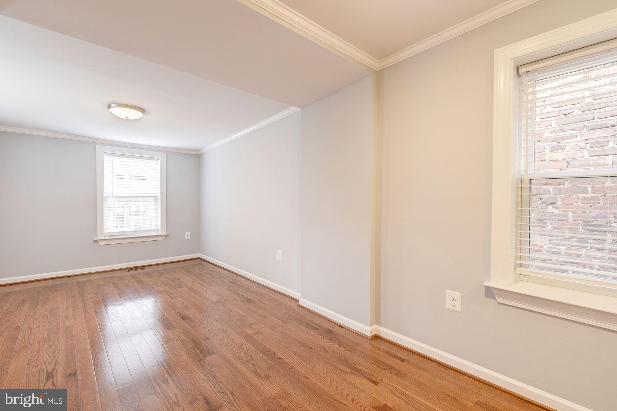 1914 10th Street Northwest Washington, DC 20001 - Photo 11 of 27 an empty room with wooden floor and windows