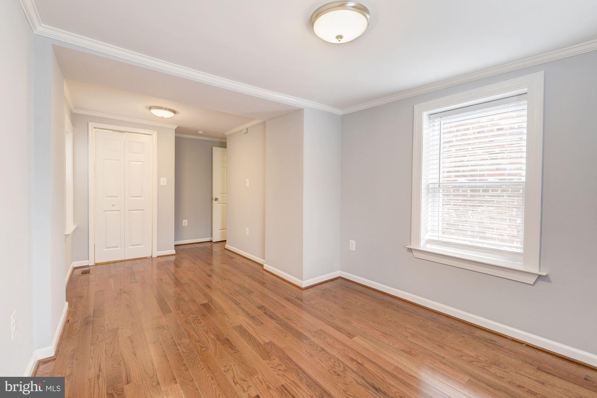 1914 10th Street Northwest Washington, DC 20001 - Photo 12 of 27 a view of an empty room with wooden floor and a window