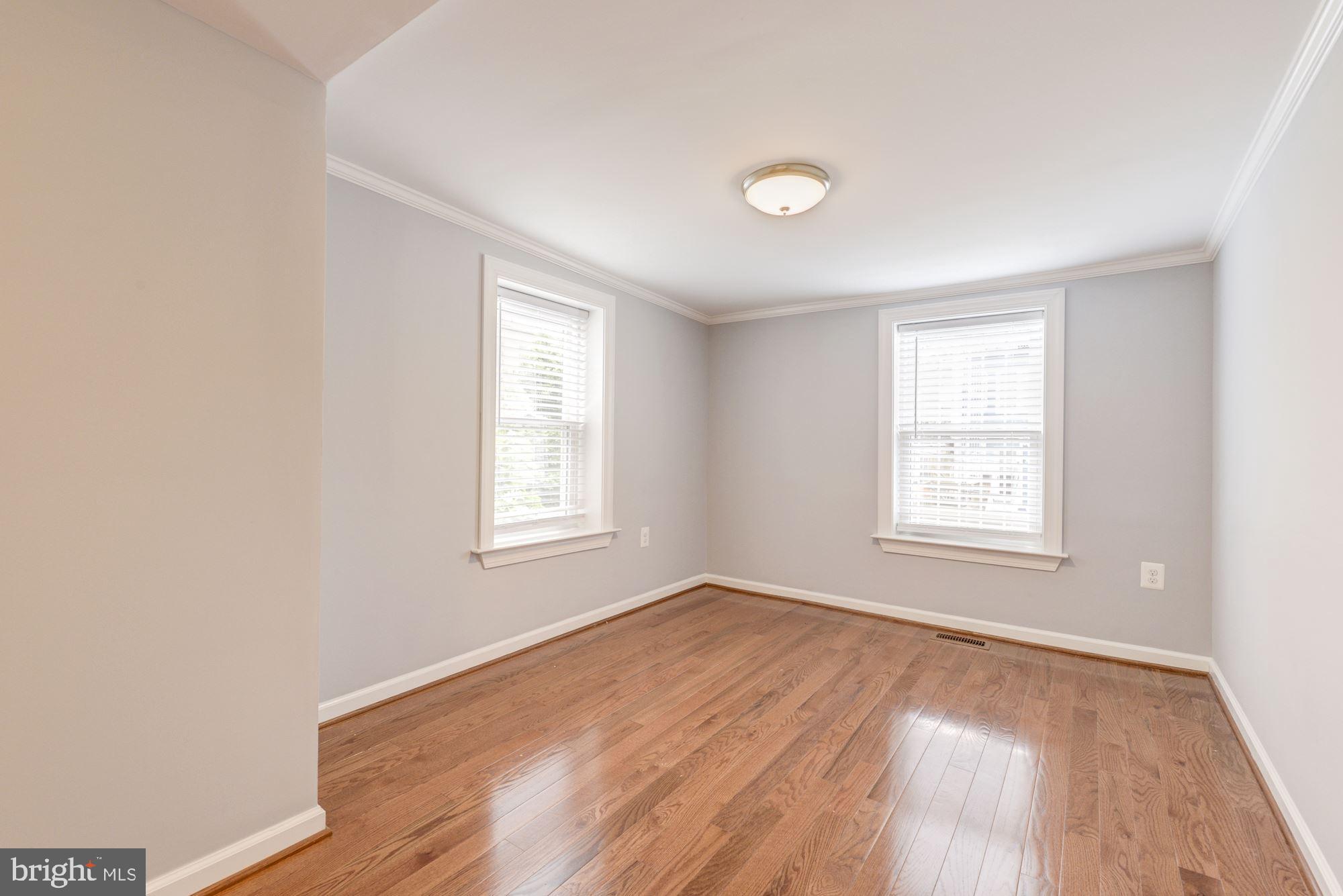 1914 10th Street Northwest Washington, DC 20001 - Photo 13 of 27 an empty room with wooden floor and windows