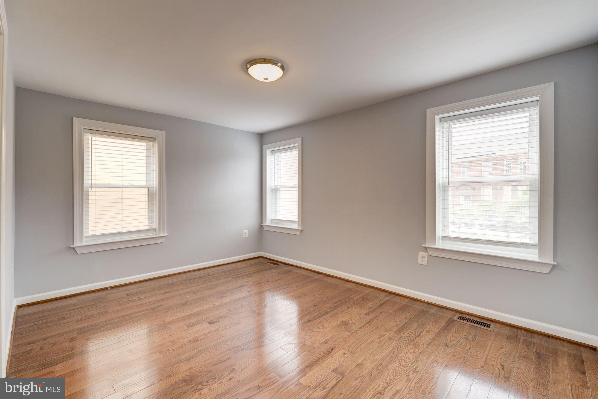 1914 10th Street Northwest Washington, DC 20001 - Photo 17 of 27 an empty room with wooden floor and windows