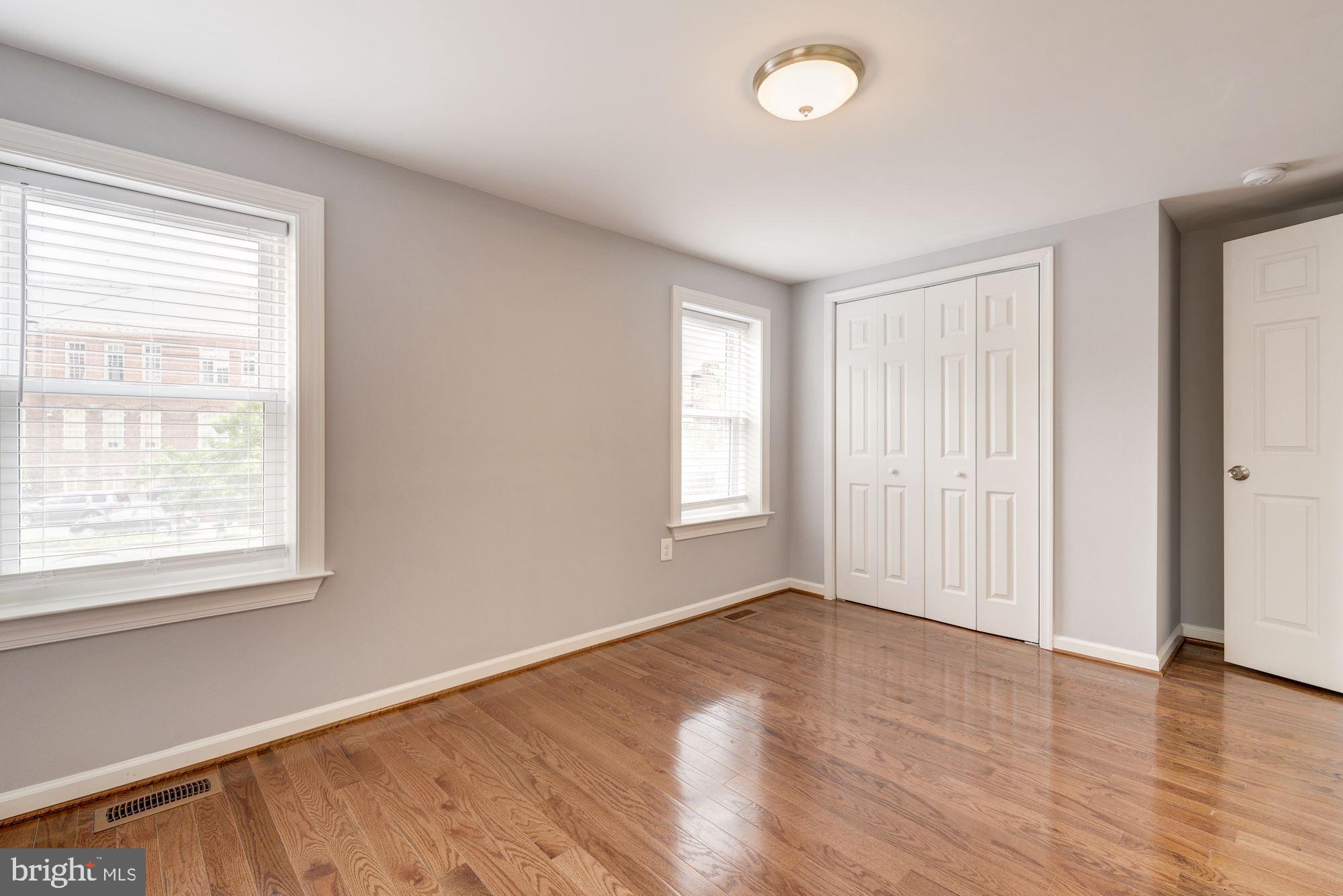 1914 10th Street Northwest Washington, DC 20001 - Photo 18 of 27 a view of an empty room with wooden floor and a window