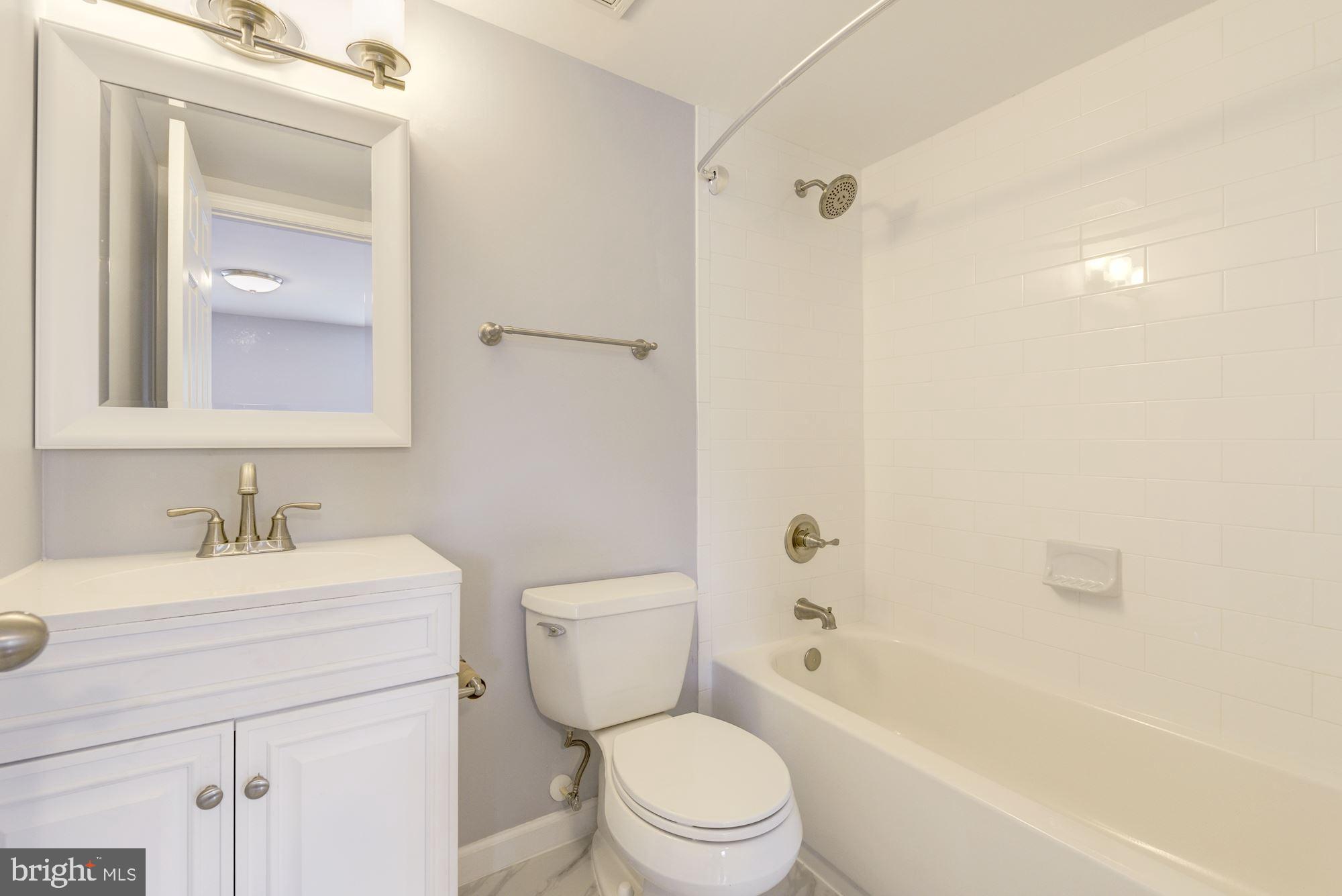 1914 10th Street Northwest Washington, DC 20001 - Photo 19 of 27 a bathroom with a sink toilet vanity and shower