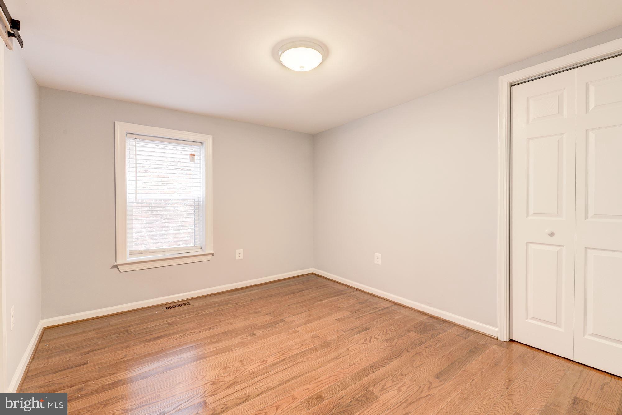 1914 10th Street Northwest Washington, DC 20001 - Photo 20 of 27 an empty room with wooden floor and windows