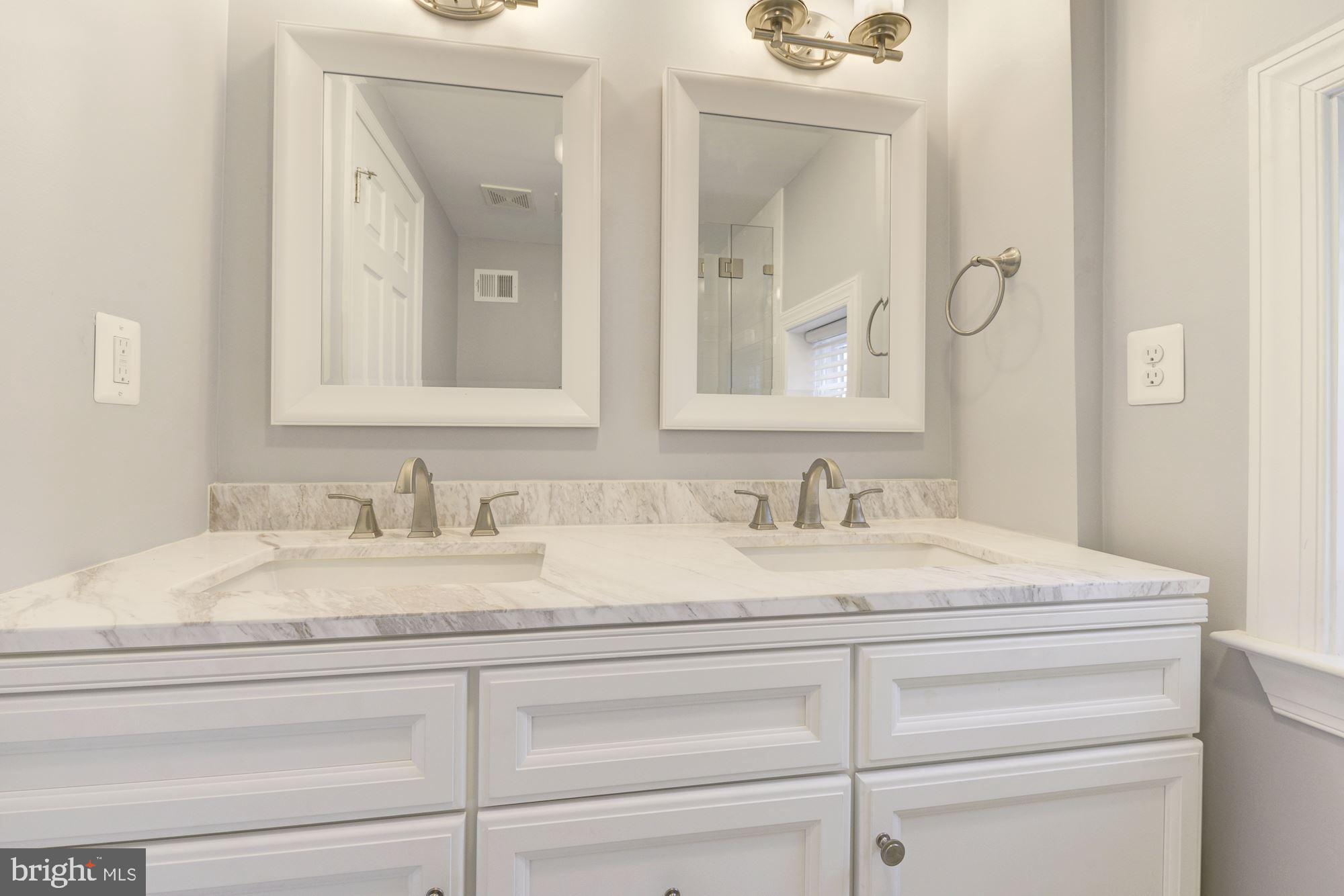 1914 10th Street Northwest Washington, DC 20001 - Photo 26 of 27 a bathroom with a granite countertop sink and a mirror