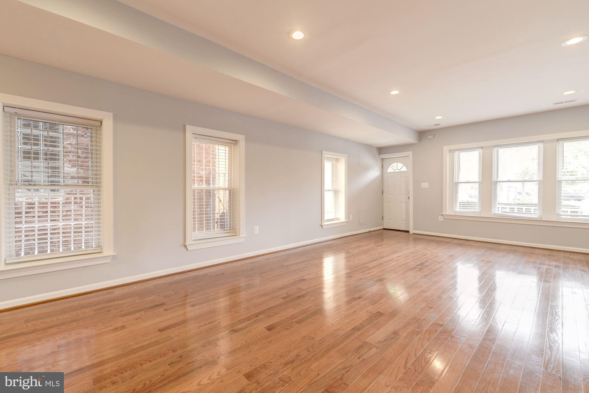 1914 10th Street Northwest Washington, DC 20001 - Photo 3 of 27 a view of an empty room with wooden floor and window