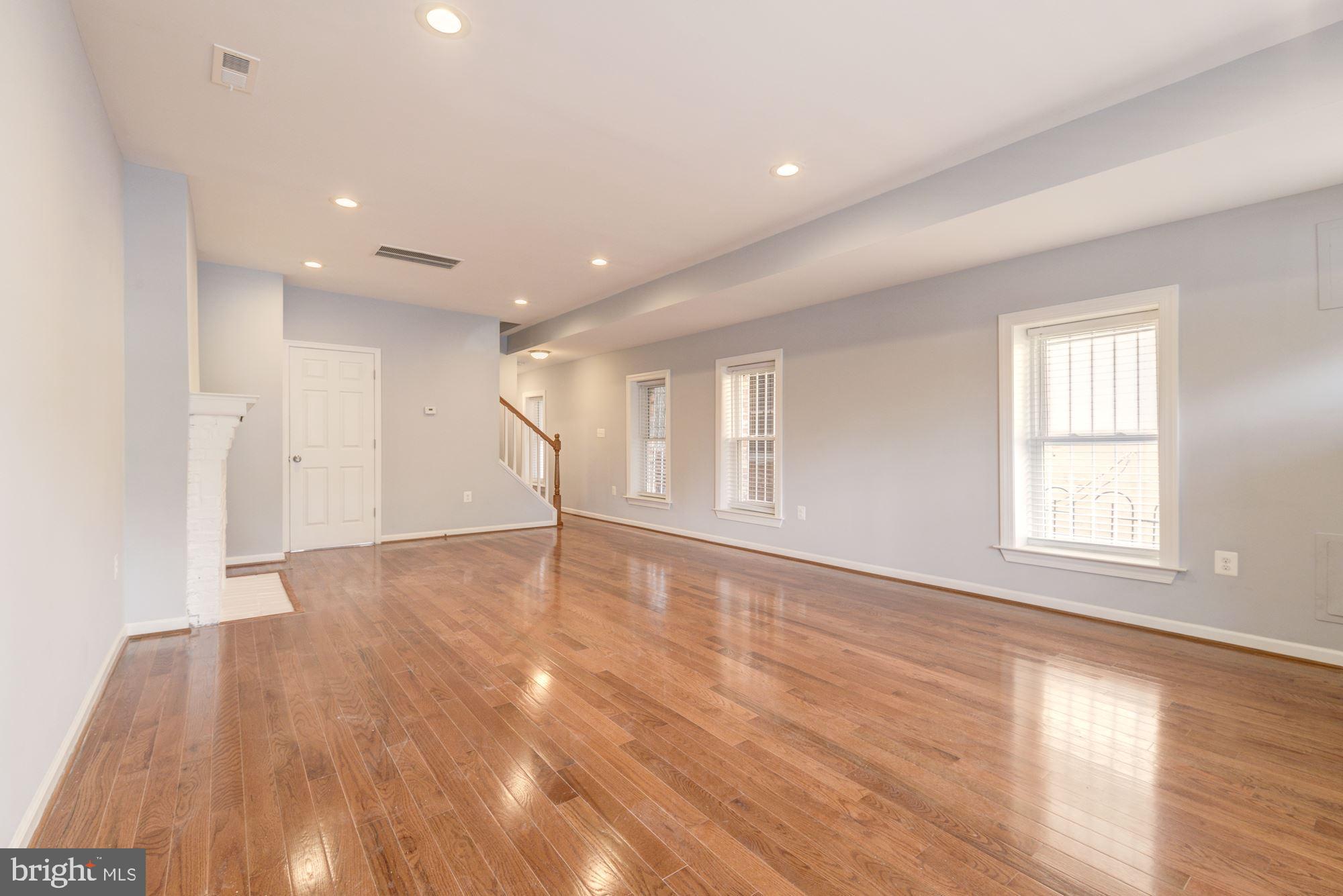 1914 10th Street Northwest Washington, DC 20001 - Photo 5 of 27 a view of an empty room with wooden floor and window