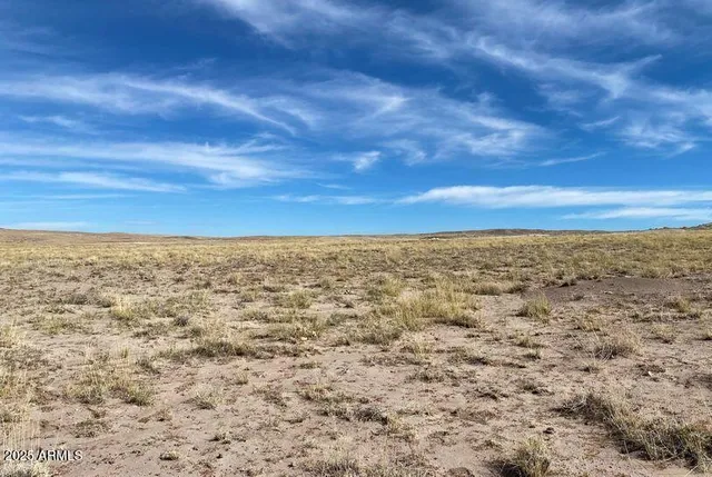 a view of a large mountain with mountains in the background