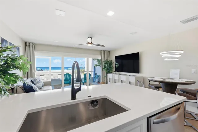 a kitchen with a wooden floor and cabinets
