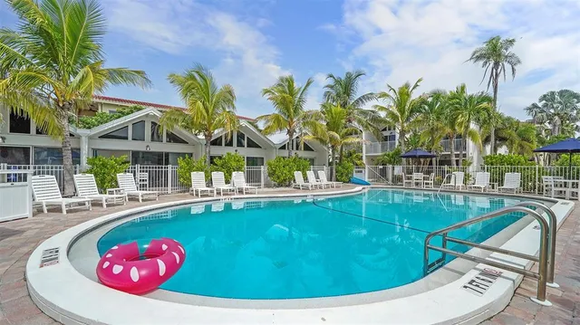 a view of multiple houses with palm trees