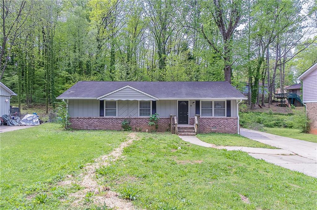 4089 Lindsey Drive Decatur, GA 30035 - Photo 1 of 1 a front view of a house with garden