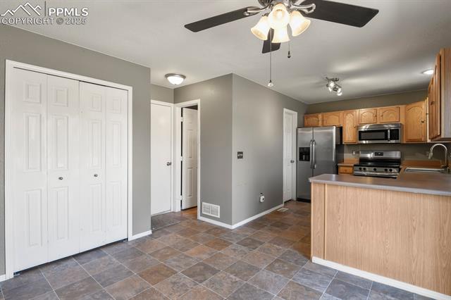 11032 Berry Farm Road Fountain, CO 80817 - Photo 13 of 35 Kitchen with stainless steel appliances.