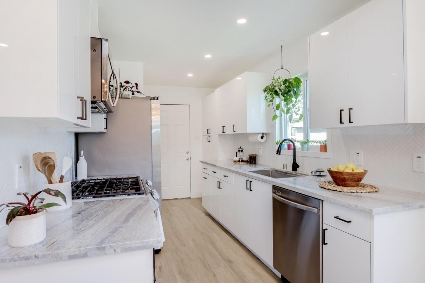 681 Arnold Drive Gilroy, CA 95020 - Photo 19 of 55 a kitchen with a sink a stove and cabinets