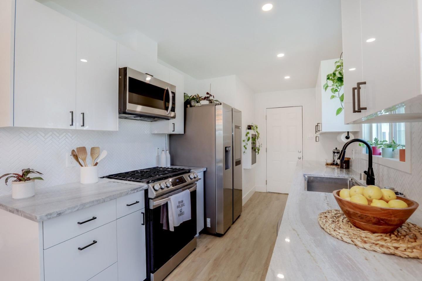 681 Arnold Drive Gilroy, CA 95020 - Photo 21 of 55 a kitchen with stainless steel appliances granite countertop a stove a sink a refrigerator and a microwave
