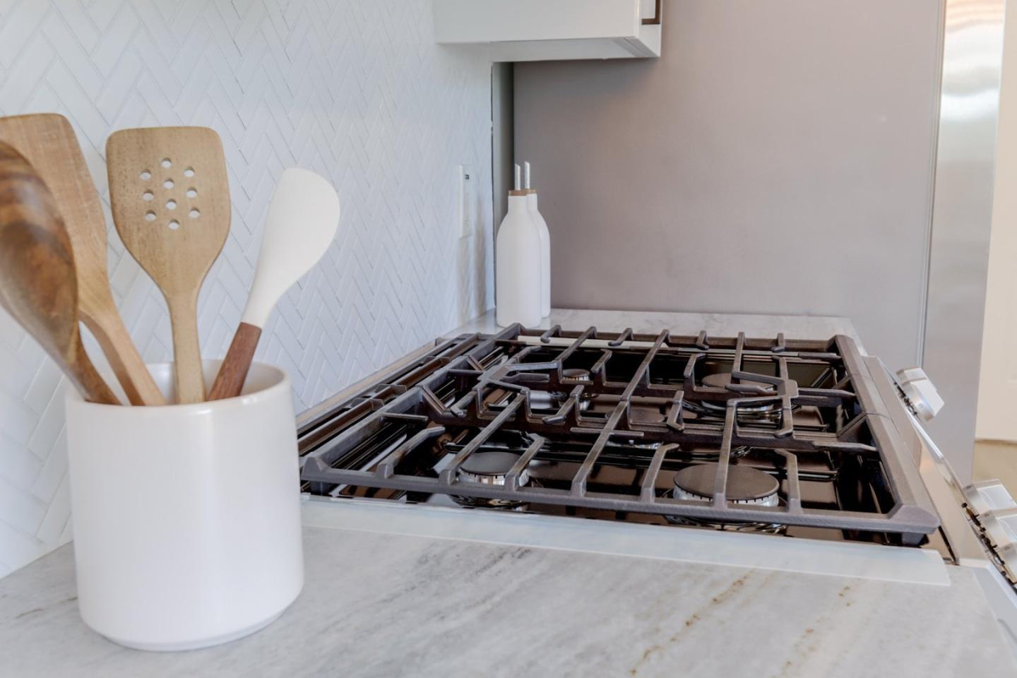 681 Arnold Drive Gilroy, CA 95020 - Photo 22 of 55 a bathroom with a black white checkered floor and a stove