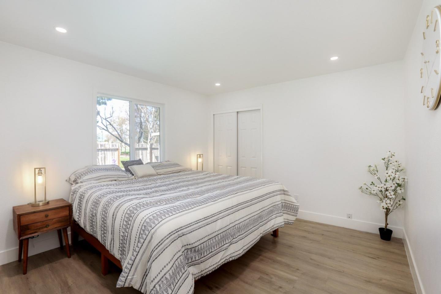 681 Arnold Drive Gilroy, CA 95020 - Photo 26 of 55 a bedroom with a bed and a potted plant
