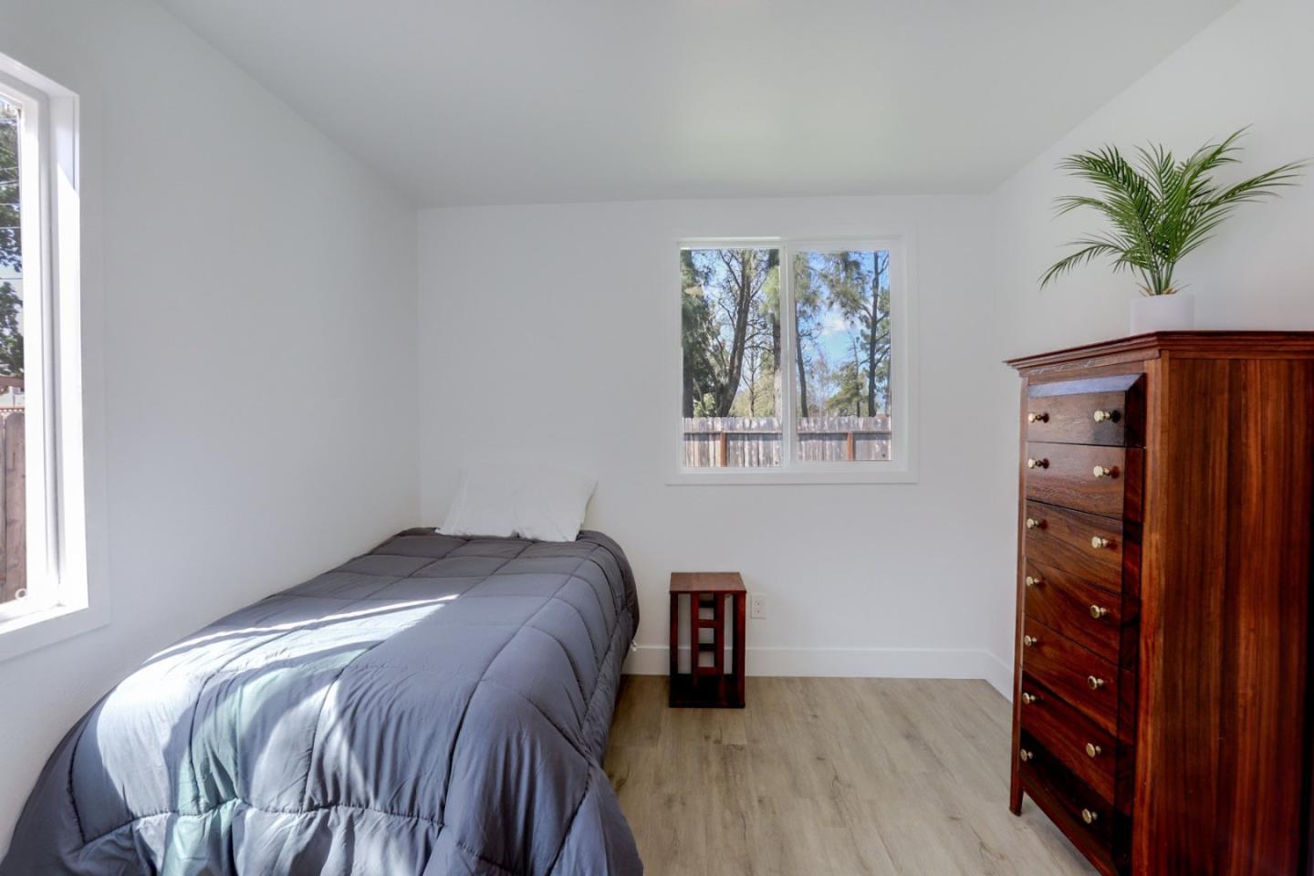 681 Arnold Drive Gilroy, CA 95020 - Photo 30 of 55 a bed sitting in a bedroom next to a window