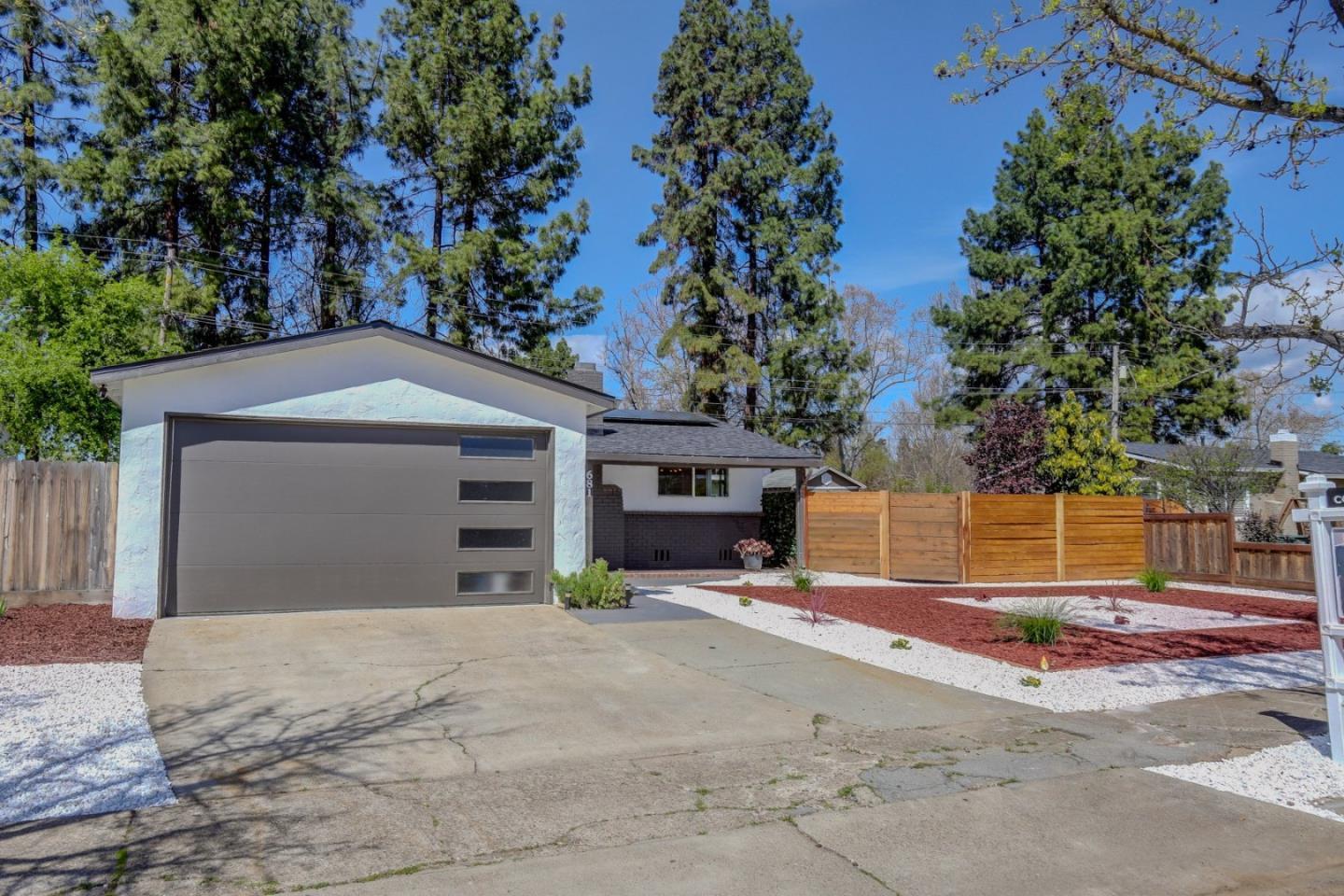 681 Arnold Drive Gilroy, CA 95020 - Photo 7 of 55 a front view of a house with a yard and garage