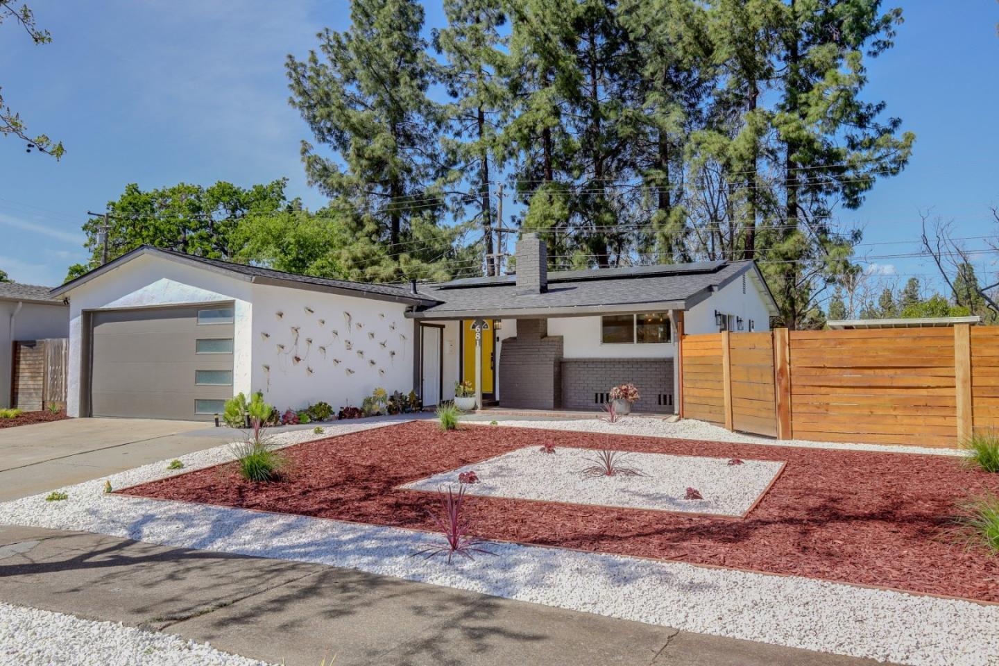 681 Arnold Drive Gilroy, CA 95020 - Photo 10 of 55 a front view of a house with a yard and garage